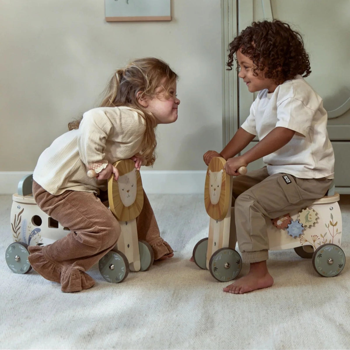 Two children riding Little Dutch Safari Friends Ride-On Lion toys
