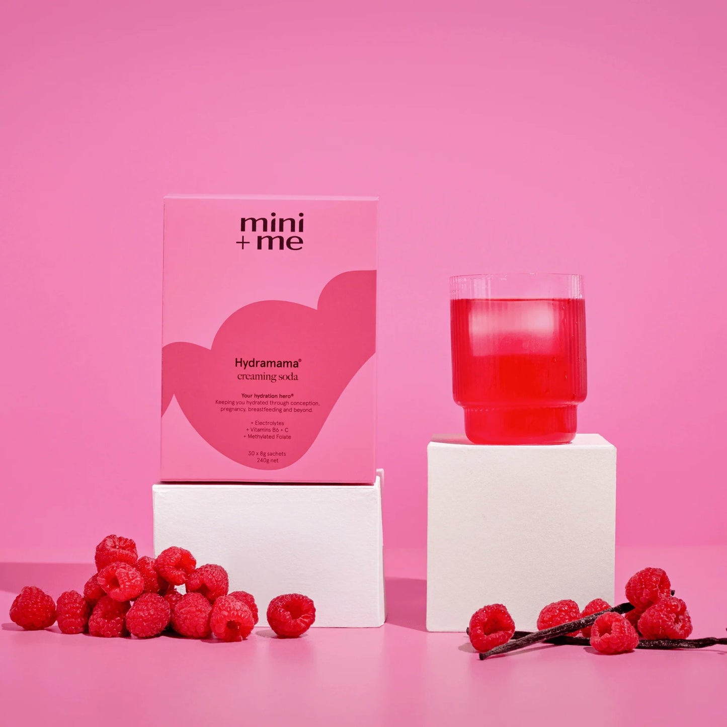 mini+me Hydramama creaming soda hydration drink mixed in a glass with fresh raspberries and vanilla