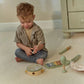 Child playing with the Little Dutch Safari Friends Music Set Green