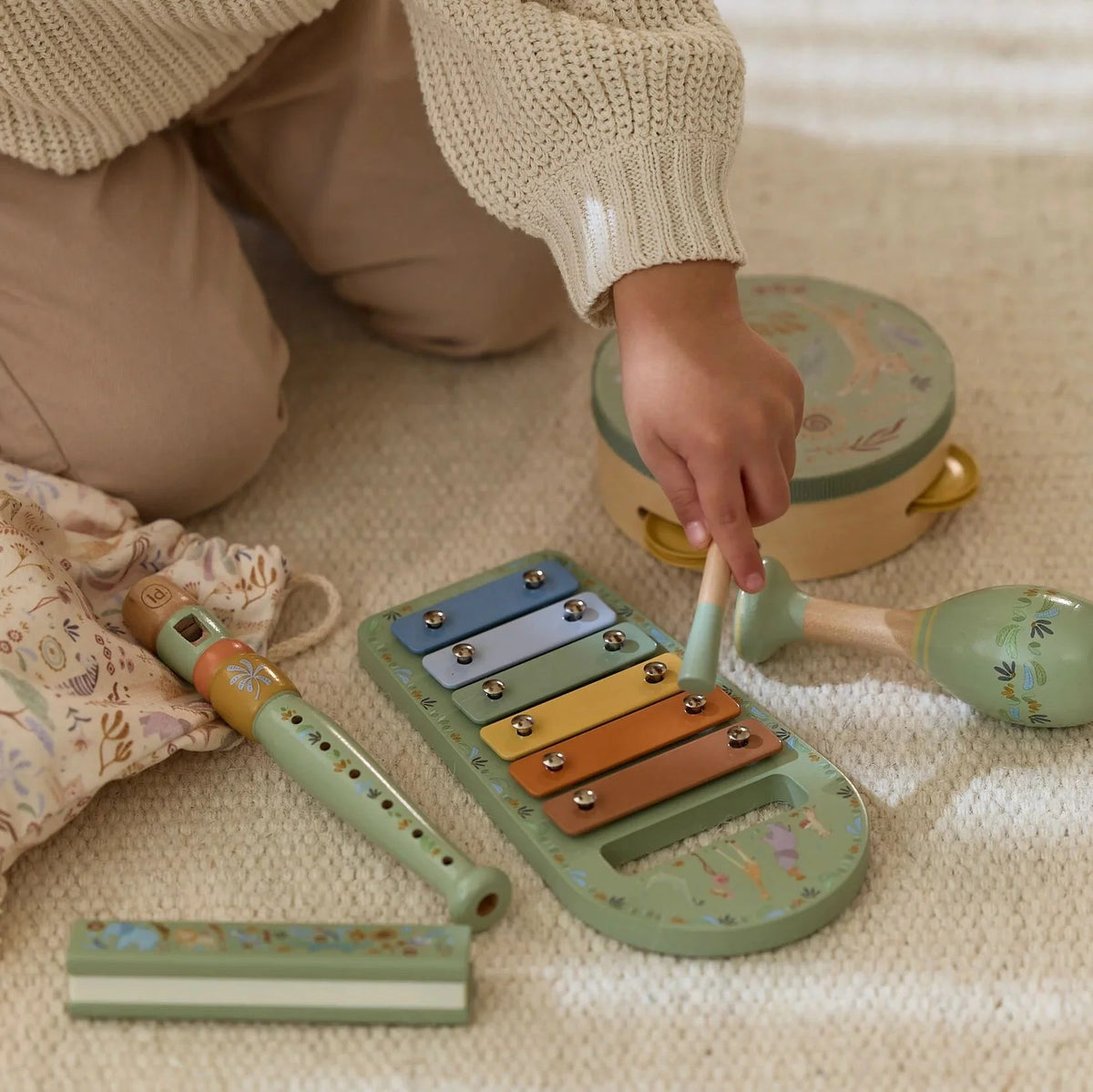 Child playing the xylophone from the Little Dutch Safari Friends Music Set Green