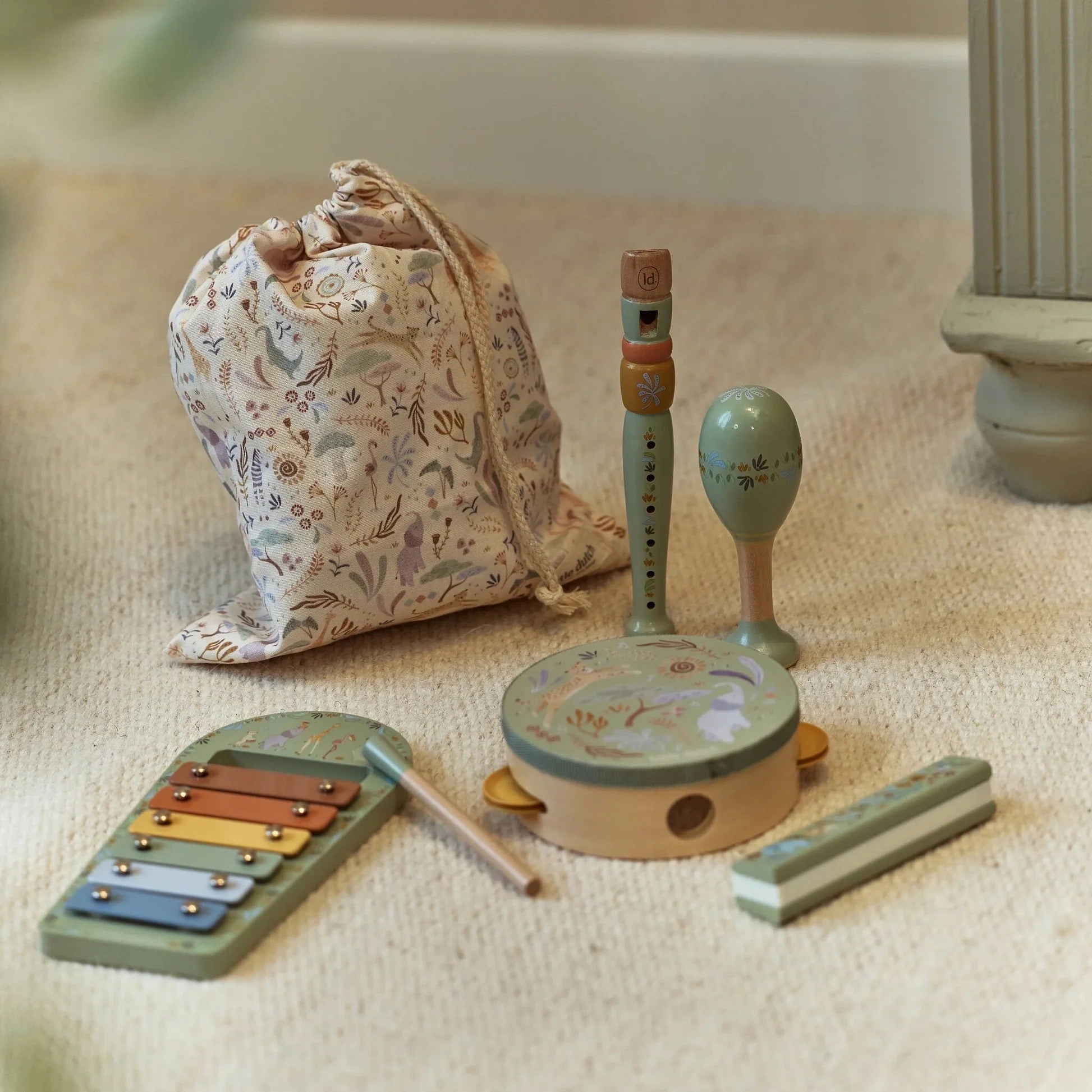 Little Dutch Safari Friends Music Set Green with instruments arranged beside the storage bag