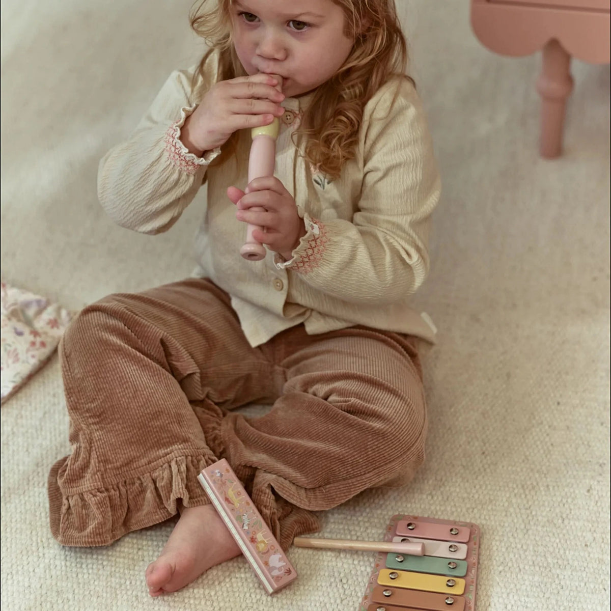 Child playing the recorder from the Little Dutch Safari Friends Music Set Pink