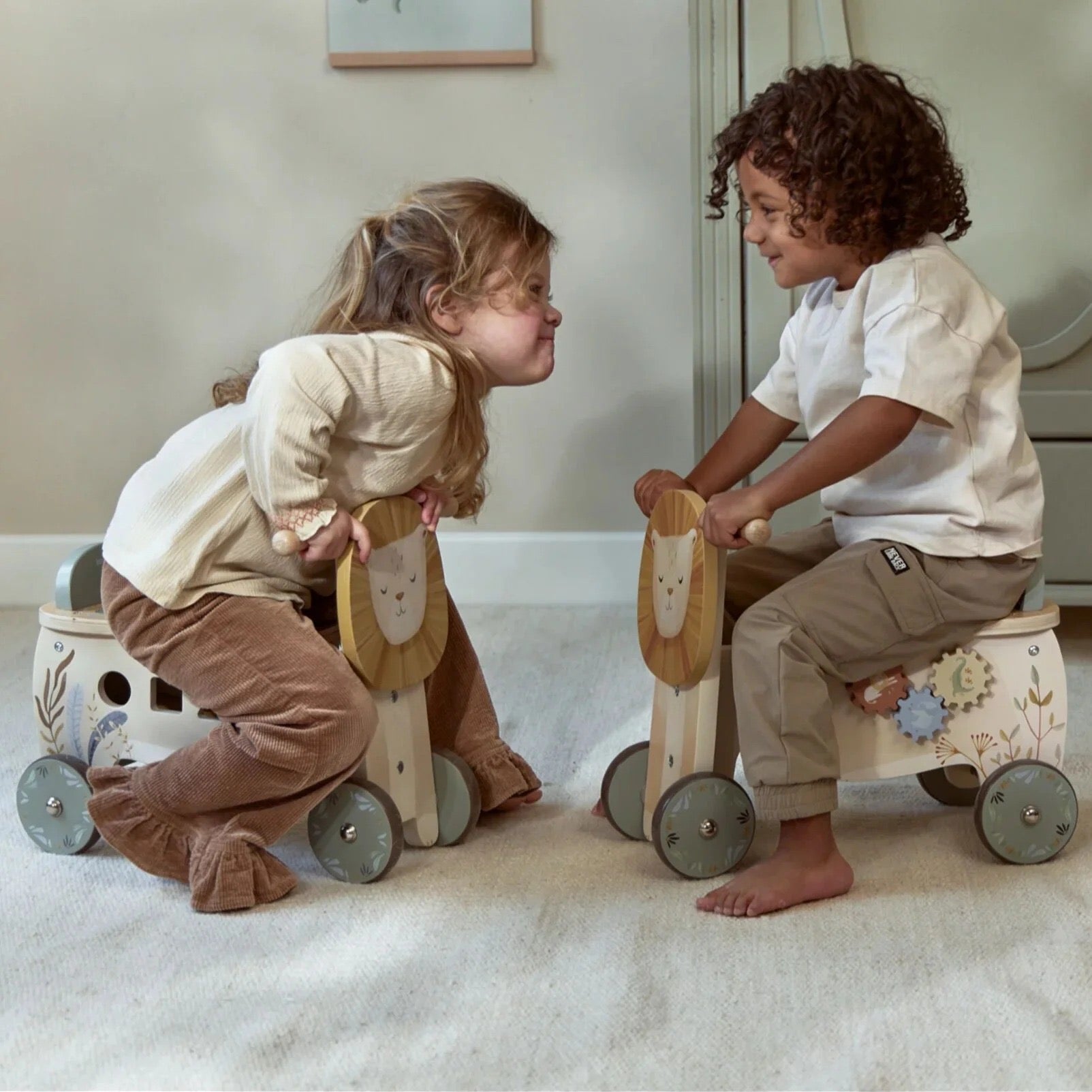Two children riding Little Dutch Safari Friends Ride-On Lion toys