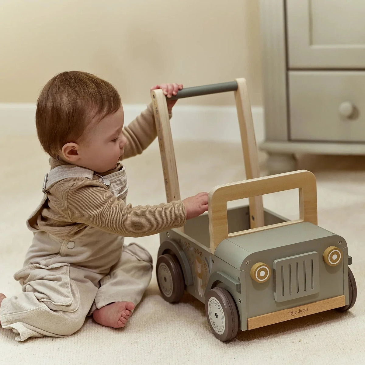 Child playing beside the Little Dutch Safari Friends Wooden Safari Car